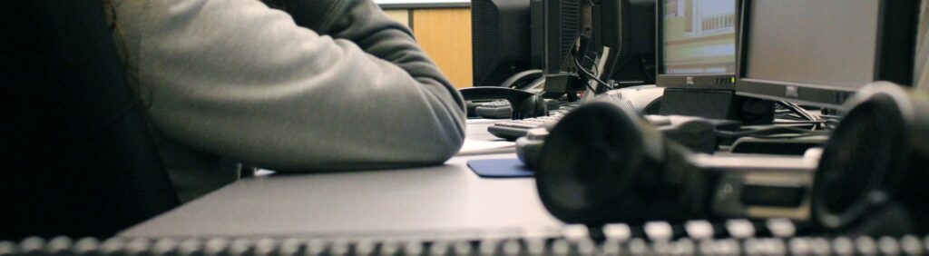 A phone receiver sits on a table during an emergency telecommunicator training course.