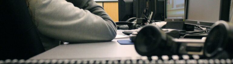 A phone receiver sits on a table during an emergency telecommunicator training course.
