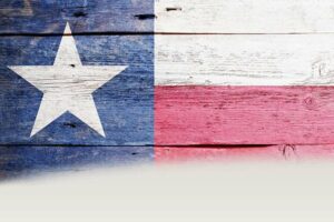 The Texas state flag painted onto wood planks.