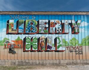 A wall mural that reads "Welcome to Liberty Hill".