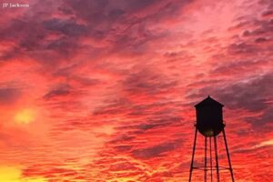 Water tower in Manor, Texas against the evening sky.